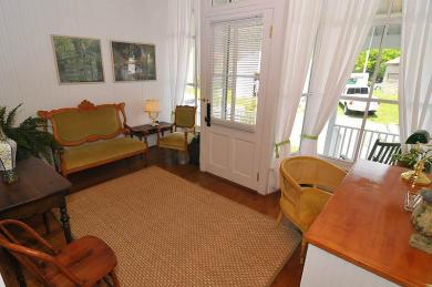 inside entrance of cottage with hardwood floors brown rug wooden desk with chairs