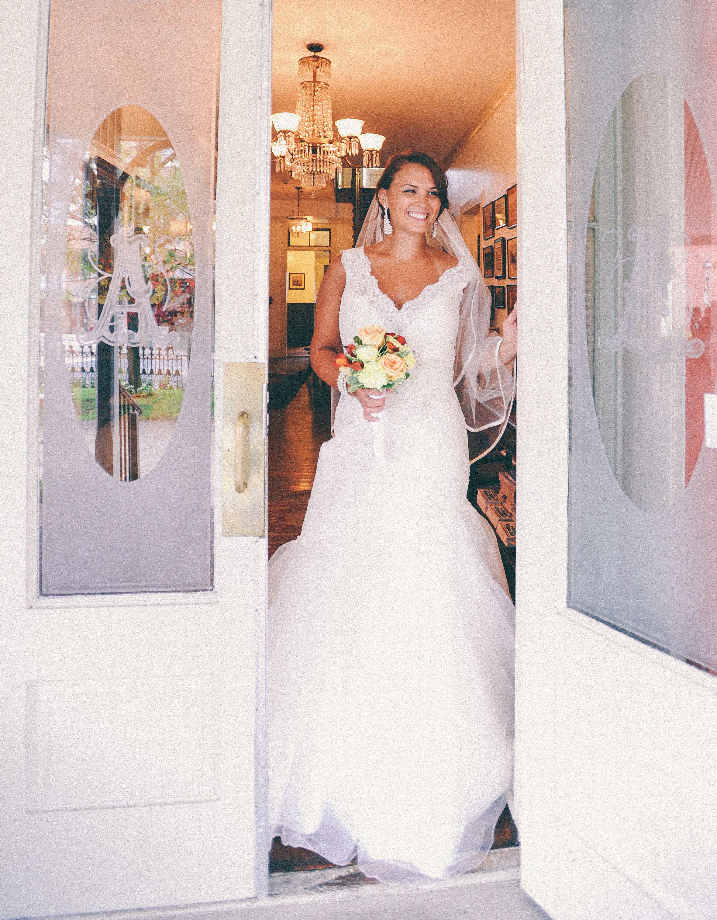 Bride holding the door open to the Atlantic Hotel Berlin MD