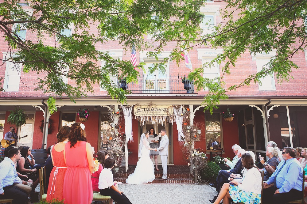 bride groom getting married at front porch of hotel atlantic berlin maryland guests sitting