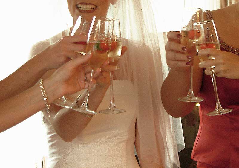 Bride toasting champagne glasses with bridesmaids at Atlantic Hotel