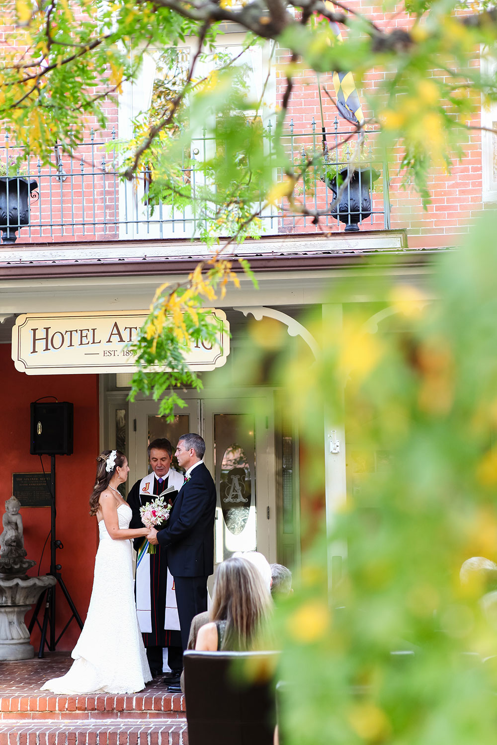 Couple exchanging vows on the front porch of the Atlantic Hotel Berlin MD