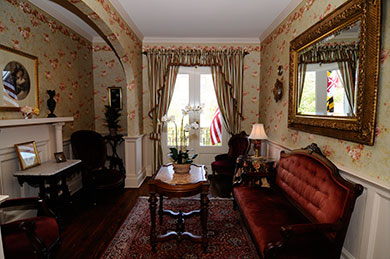 hotel ladies parlor room with window mirror sofa and tables