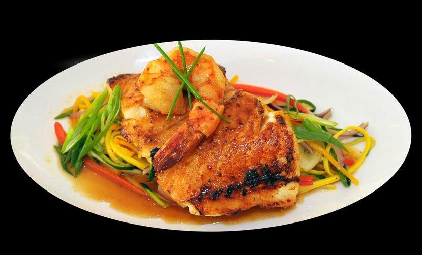 seafood entree on white plate shrimp fish julianne vegetables