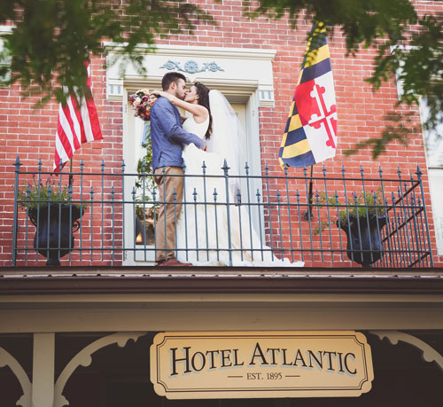 bride groom kissing on hotel balcony