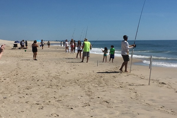 people fishing on beach